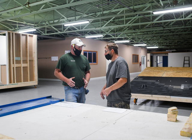 master-craft-workers talking in a manufacturing plant